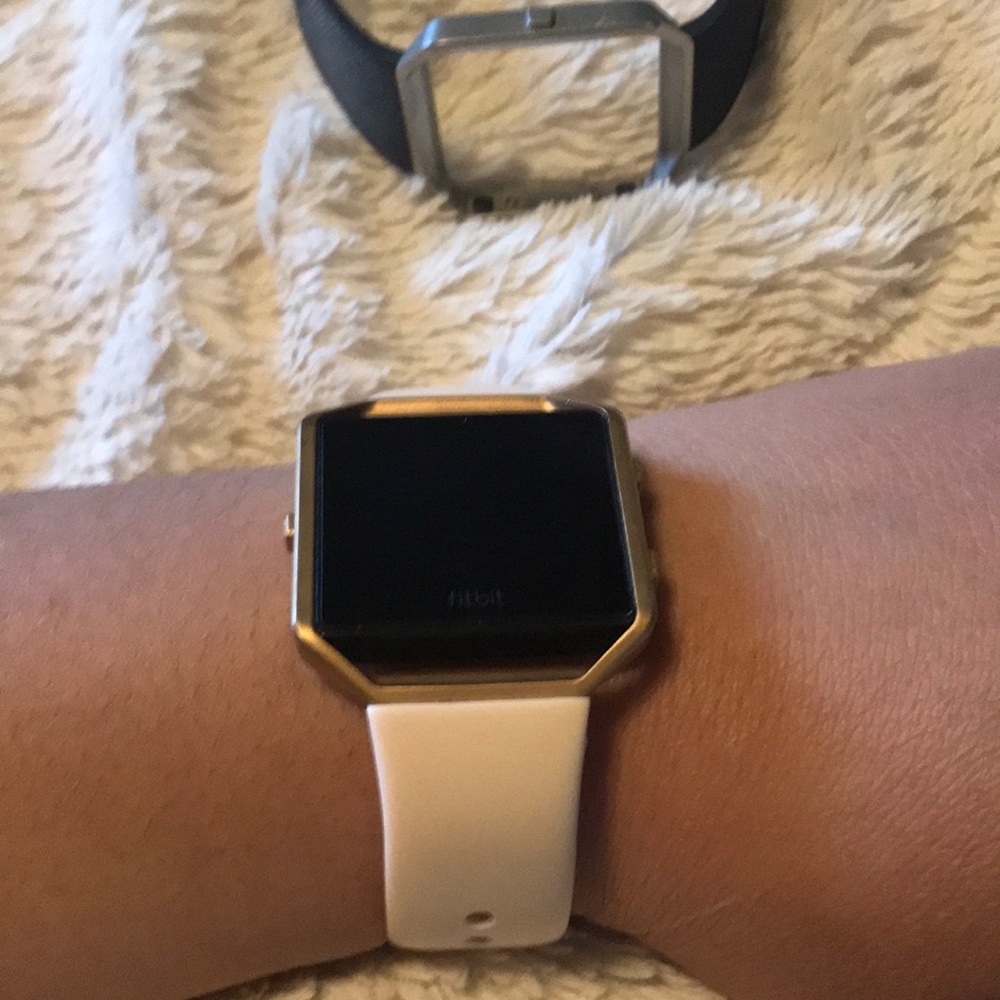 Fitbit watch, pink band and usb